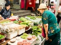 Seoul, South Korea - June 26, 2017: Elderly woman buys greens at Gwangjang Market in Seoul