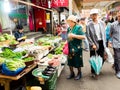 Seoul, South Korea - June 26, 2017: Elderly woman buys vegetables and greens at Gwangjang Market in Seoul