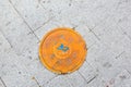 Seoul, South Korea - June 25, 2017: Round yellow sewer hatch on the street in Seoul downtown.