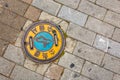 Seoul, South Korea - June 25, 2017: Round yellow sewer hatch on the street in Seoul downtown.