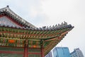 SEOUL / SOUTH KOREA - JUNE 24, 2013: Traditional temple with modern skyscraper in background - Historic culture and economic futur