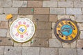 Seoul, South Korea - June 25, 2017: Two round sewer hatches on the street in Seoul