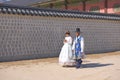 Seoul, South Korea, November 2018:Korean mature couple dressed Hanbok in traditional dress walking in Gyeongbokgung Palace, Seoul Royalty Free Stock Photo