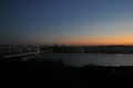 SEOUL, SOUTH KOREA - OCTOBER 24, 2022: Calm Sunset scene with colourful bridge, buildings, and Han river and dark sky