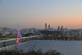 SEOUL, SOUTH KOREA - OCTOBER 24, 2022: Calm Sunset scene with colourful bridge, buildings, and Han river and vanilla sky