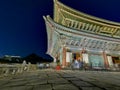 SEOUL, SOUTH KOREA - OCTOBER 23, 2022: Light up of Gyeongbokgung Palace main hall at night. There are blurly scene of movement