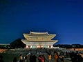 SEOUL, SOUTH KOREA - OCTOBER 23, 2022: Light up of Gyeongbokgung Palace main hall at night. There are many tourists wear