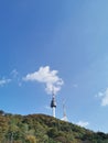 SEOUL, SOUTH KOREA - OCTOBER 23, 2022: N Seoul Tourist Sigthseeing tall tower above Namsan mountain hill and blue sky with Autumn Royalty Free Stock Photo
