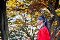 SEOUL, SOUTH KOREA - OCTOBER 23, 2022 Traditional Korean Kingdom Soldier Warrior stands to guard among Autumn foliage leaves in