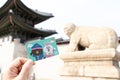 Seoul, South Korea- Sep 25, 2019 : Traveller hand hold t money card with line cartoon character on defocused Haechi statue in