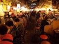 People eating in the restaurants in an alley of the Namdaemun market. Seoul