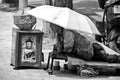 Seoul South Korea street, a crippled beggar under umbrella