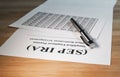 SEP IRA paper document on wood table with pen and calculations Royalty Free Stock Photo