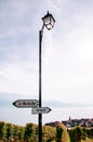 Street light pole with destination signs and lake Geneva view in Chexbres village in Lavaux near Vevey and Montreux
