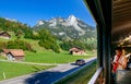 Swiss rural farmland peaceful scenery through train window with tourist