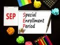 SEP symbol. Concept words SEP Special enrollment period on beautiful white note. Beautiful black table black background.