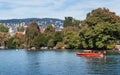 Lakeside park and wooden boat in lake Zurich