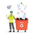 Separate garbage collection. Caucasian man in uniform stands near trash can. Plastic items fall into separate tank