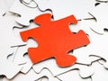 Separate red piece on pile of white jigsaw puzzles Royalty Free Stock Photo