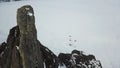 Separate stone cliff near the coast of Lake Baikal, Siberian winter nature. Clip. Aerial view of the rock with steep Royalty Free Stock Photo