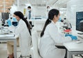 Separate but together in the zone. two female scientists working together in the lab. Royalty Free Stock Photo