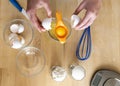 Separating yellow yolks from protein in raw eggs for cake, biscuit and cream Royalty Free Stock Photo