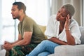 Separation, conflict and couple on a couch, ignore and anger with depression, argument and divorce. Relationship, black Royalty Free Stock Photo