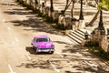 Sepia - American pink 1956 vintage car on the high angle view drives on the street Jose Marti in Havana City Cuba - Serie Cuba