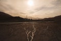 Sepia effect on a landscape with a road mountains and the sun shining above