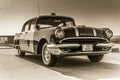 Sepia image of Pontiac model driven by the Highway Patrol