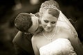 Sepia kissing the tattoo bride on their neck skin wedding
