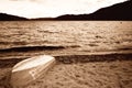 Sepia of an old lake boat waiting to be used on this windy lake Royalty Free Stock Photo