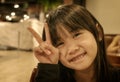 Sepia Portrait of a Little Asian Girl With Gesturing a Peace Sign Royalty Free Stock Photo