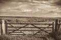 Sepia retro vintage image of wooden gate in rural countryside Royalty Free Stock Photo