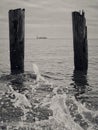 Horizon over water with two wooden stakes and water splash