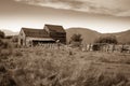 Sepia tone photo of old barn and corral