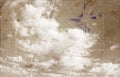 Sepia toned image of clouds in te sky. image is textured with paper texture and stains, vintage look style