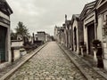 Sepia toned view of a row of family mausoleums in Cimetiere Montmartre, Paris, France