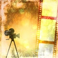 Sepia vintage background with film strip and old cinecamera. Royalty Free Stock Photo