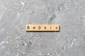 Sepsis word written on wood block. Sepsis text on cement table for your desing, concept