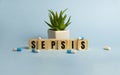 Sepsis word written on wood block. Sepsis text on blue for your desing, concept