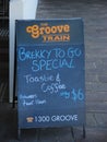 Brekky to Go Special Sign on sidewalk by stairs
