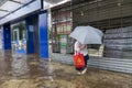 After heavy rain in Hong Kong, citizens walk in muddy water on the flooded street of Lung Cheung Road in Wong Tai Sin.