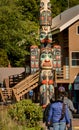 Sept. 17, 2018 - Ketchikan, AK: Three tourists viewing Chief Johnson Totem Pole on sunny day.