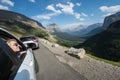 SWIFTCURRENT, MT: Blonde female admires the beautiful mountain scenery along Going to the Sun Road in Montana from