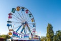 Sept. 2, 2012 - Vancouver, Canada: Colourful fairground ferris wheel and midway at PNE fair on a sunny afternoon.