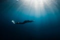 September 10, 2020. Anapa, Russia. Professional free diver in wetsuit with mono fin underwater in sea