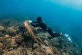 September 10, 2020. Anapa, Russia. Professional freediver in wetsuit with mono fin underwater in sea. Freediving in Black sea