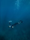 September 10, 2020. Anapa, Russia. Professional freediver in wetsuit with mono fin underwater in sea. Freediving in Black sea