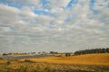 September autumn time rural landscape country side scenic view yellow field space with solar factory in cloudy weather day